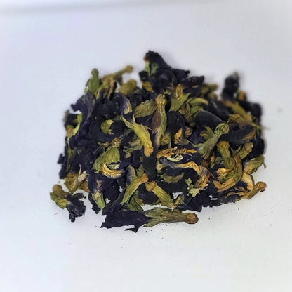 Dry blue tea leaves on a white background