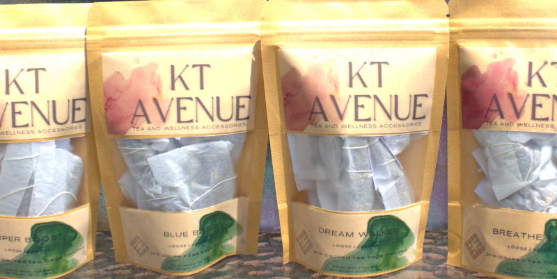 KT Avenue tea bags in clear packaging on a wooden surface